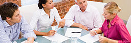 people sitting around table at mediation session